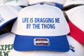 Life Is Dragging Me By The Thong OTTO Trucker Hat